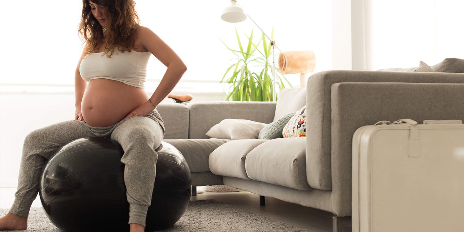 Pregnant woman sitting on gym ball