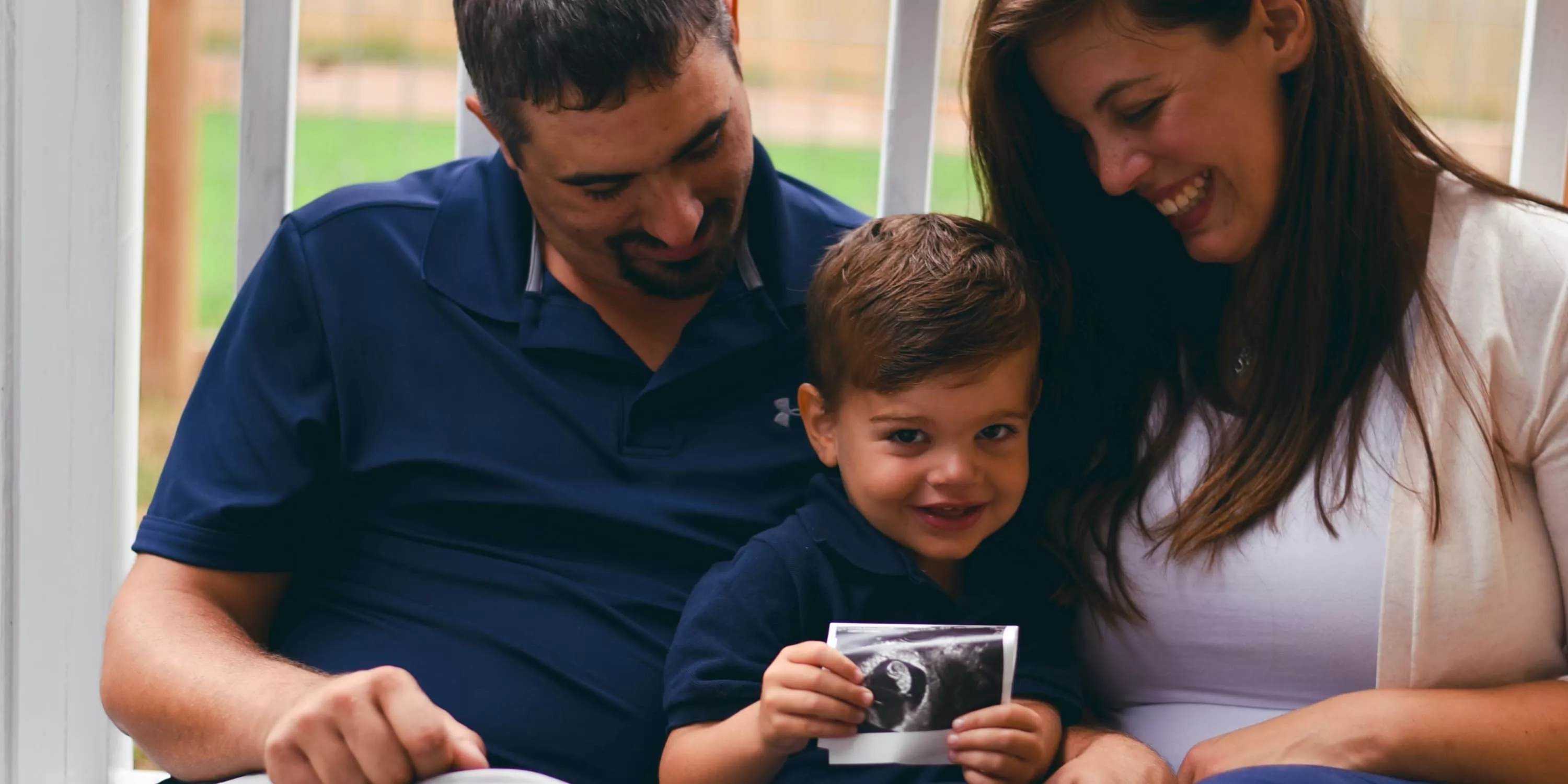 Happy family with ultrasound image
