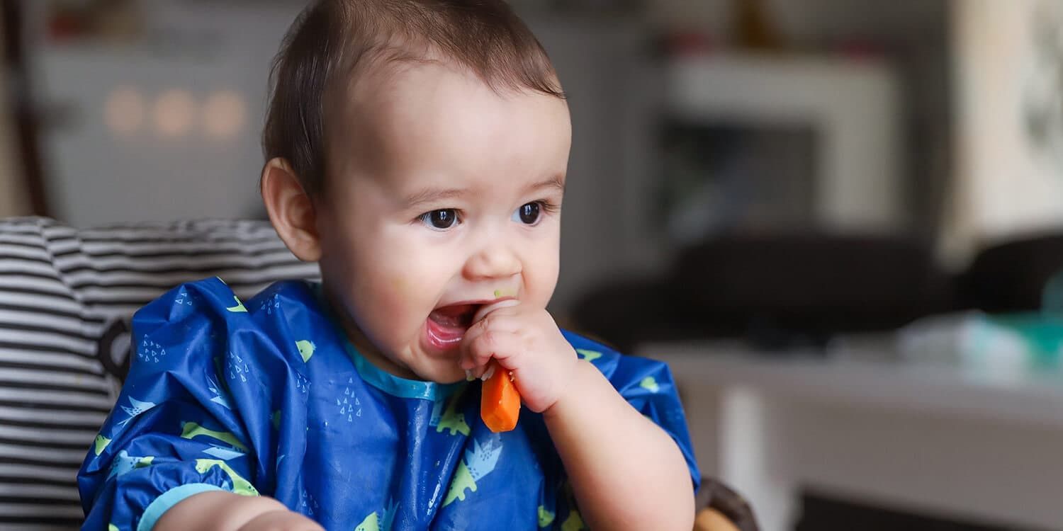 Baby eats cooked vegetables