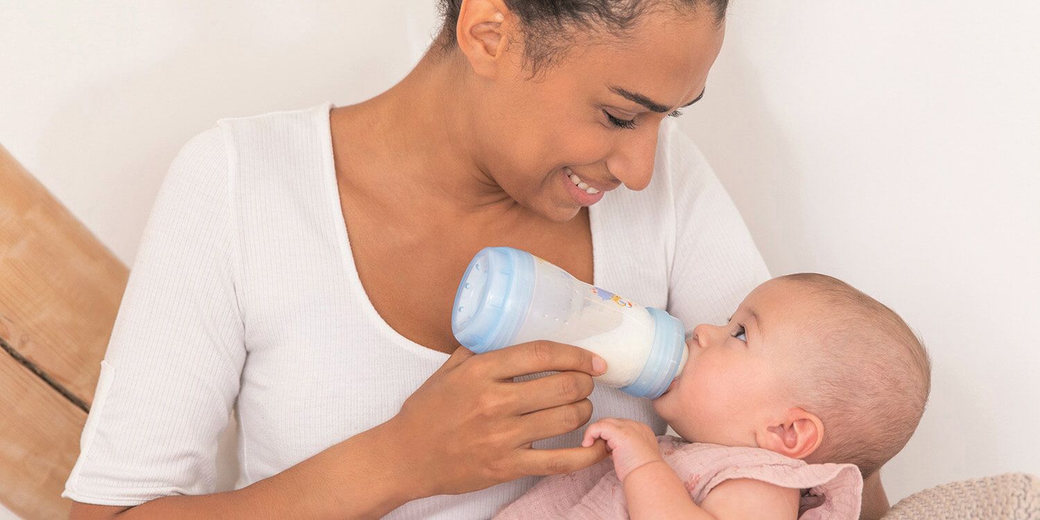 mother feeding baby with bottle