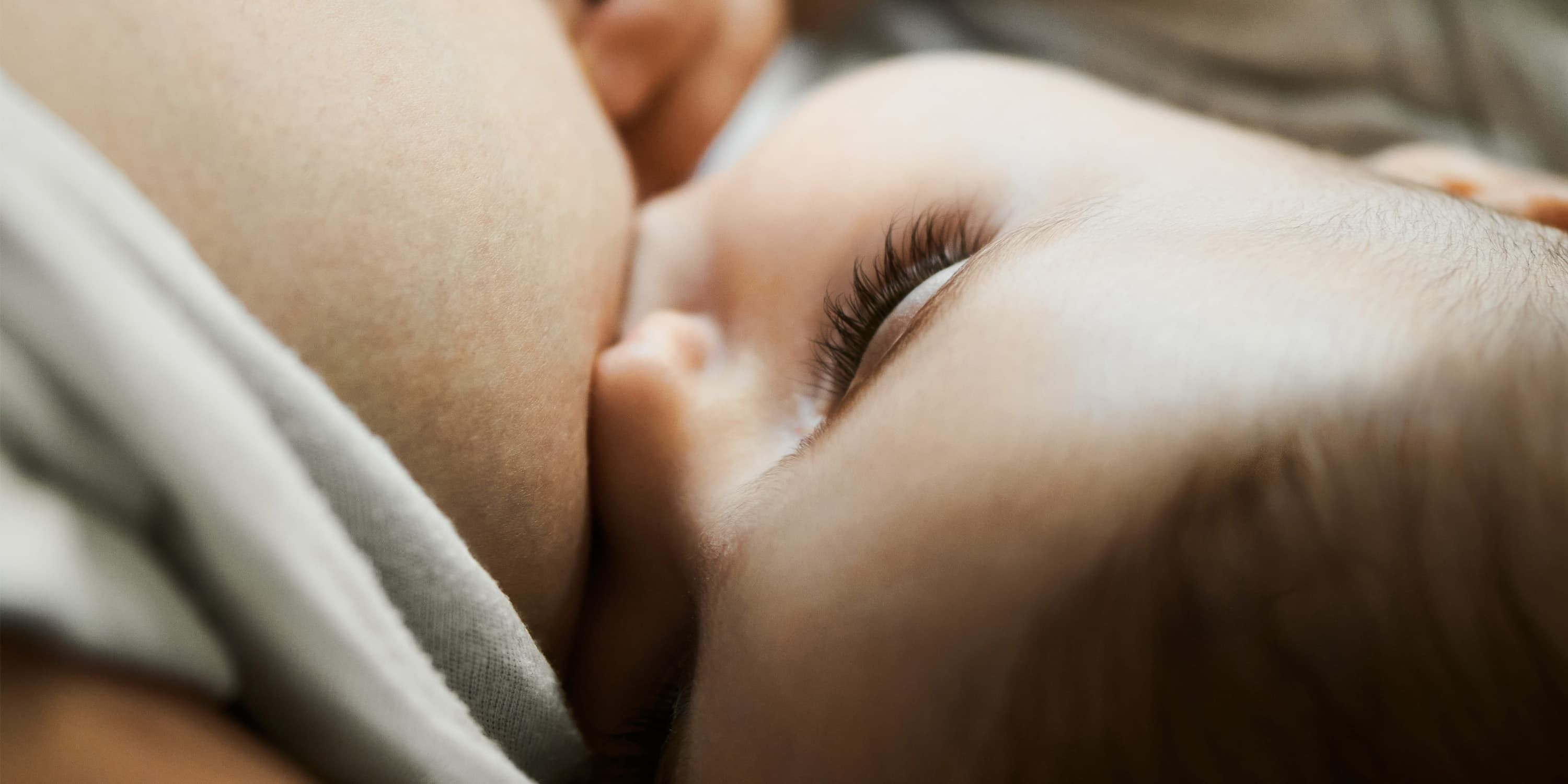 Close up, baby drinking at mother's breast