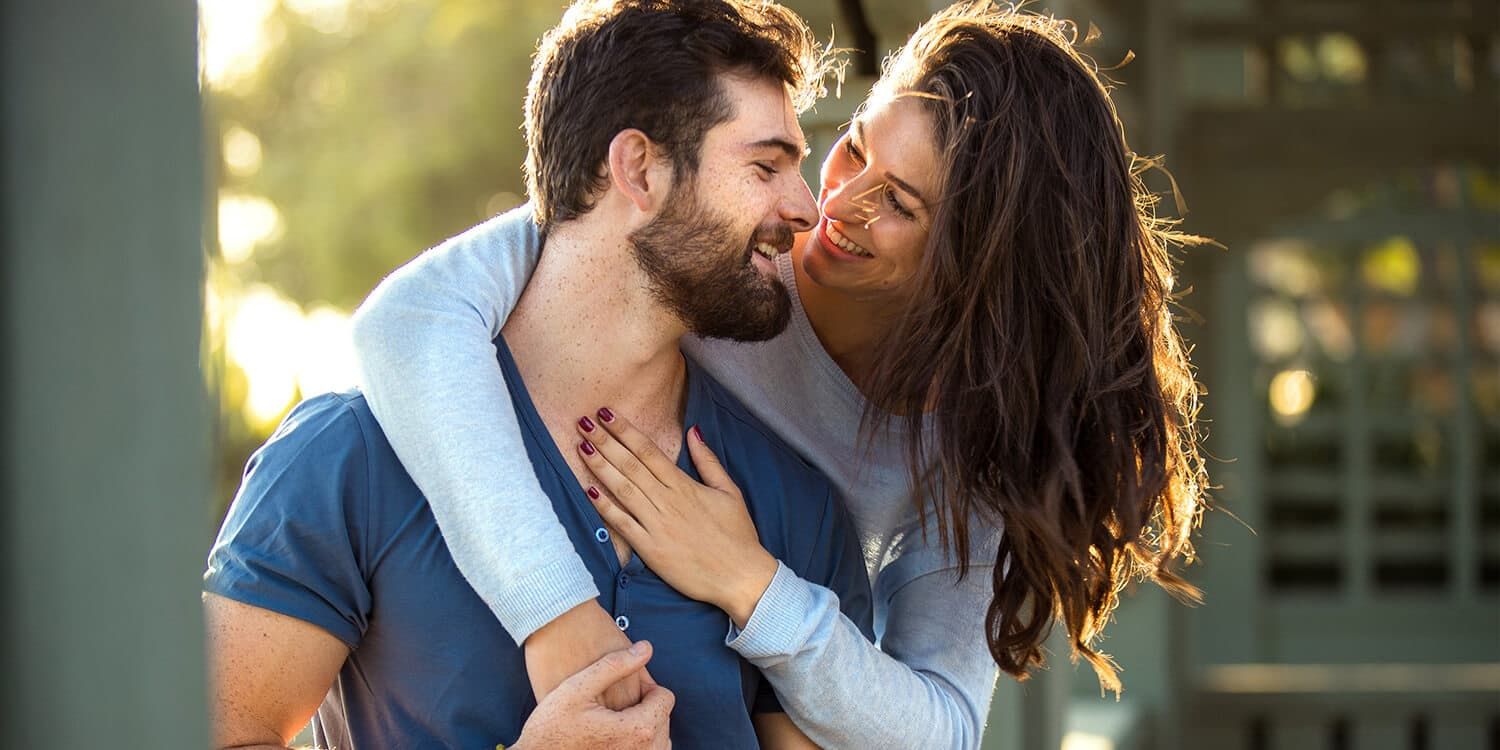 woman hugging  man and smiling