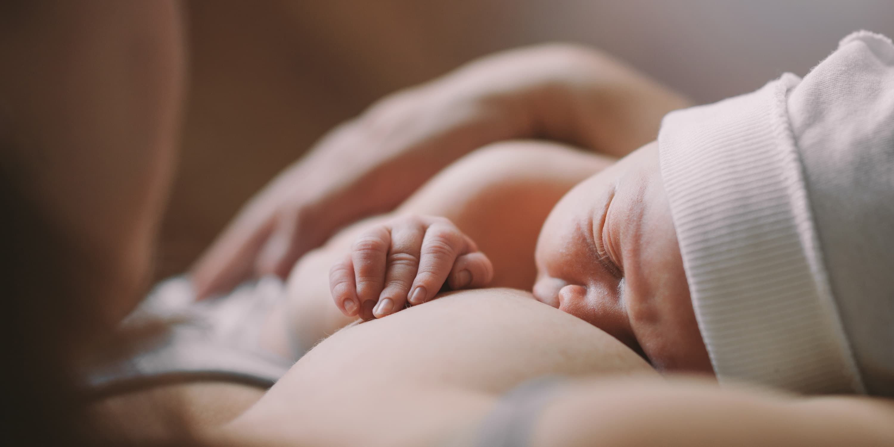 Close up, baby drinking at mother's breast