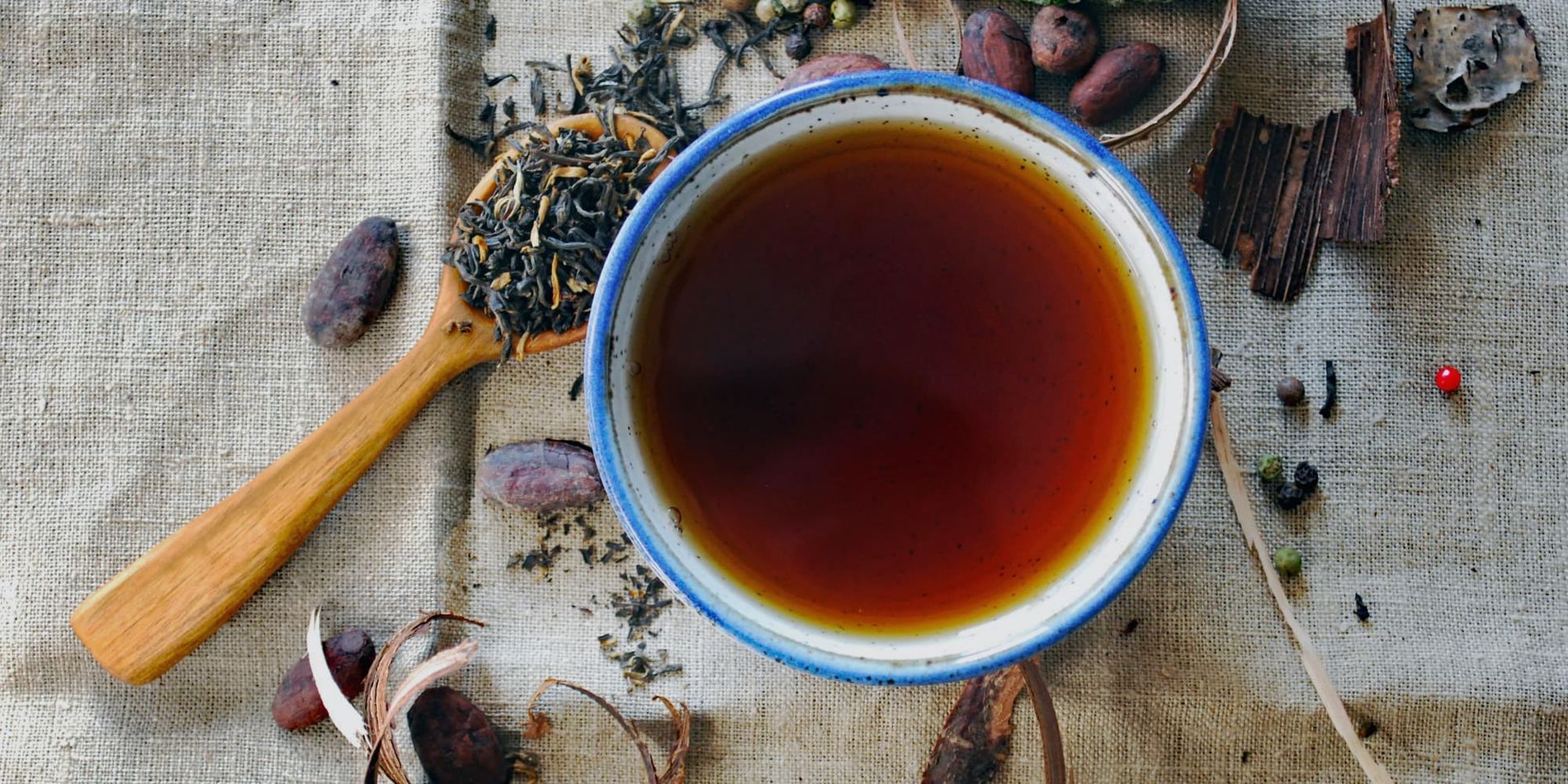 Tea and herbs are prepared on a table.